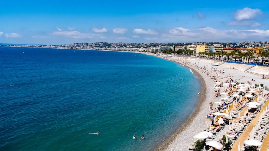 An aerial perspective of crystal clear turquoise waters and rugged cliffs along the Turkish Mediterranean coastline.