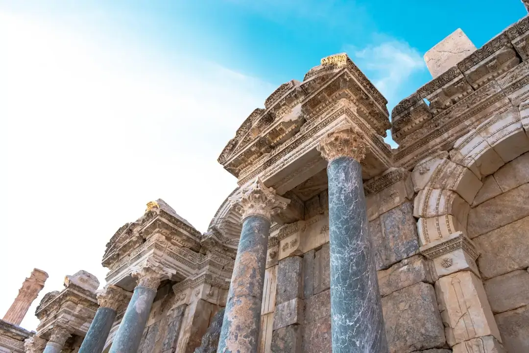 Panoramic view of ancient stone columns and archaeological ruins overlooking the Mediterranean sea in Cyprus.