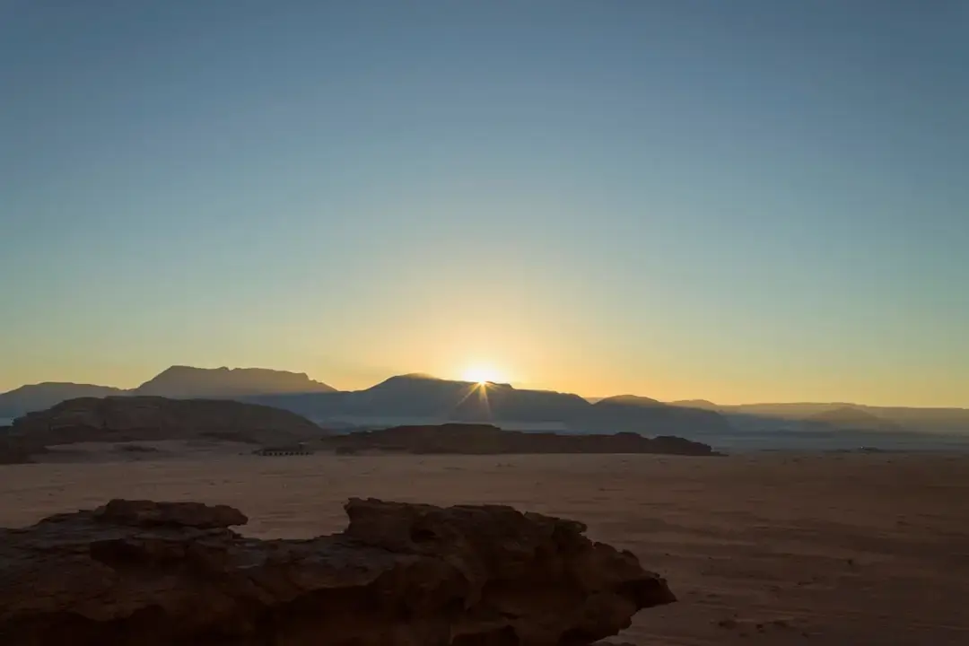 Panoramic view of the vast red sand dunes and ancient rock formations in the Jordan desert