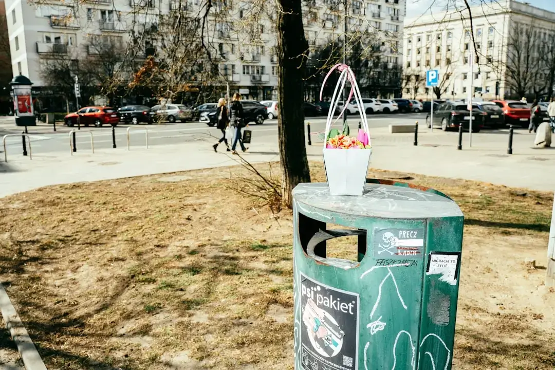A row of modern, color-coded recycling bins for sorting trash, plastic, and paper in an eco-friendly setting.