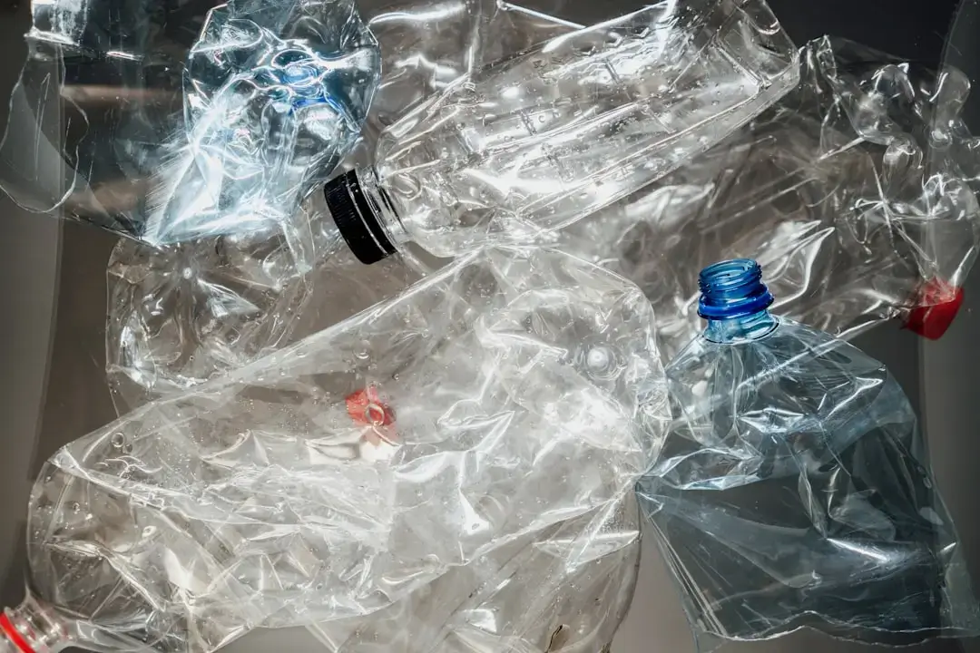 A vibrant assortment of various colored plastic bottles crushed and sorted together, ready for the recycling process.