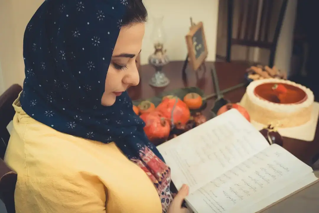 A person holding a food product and carefully reading the nutrition facts label in a grocery store aisle.