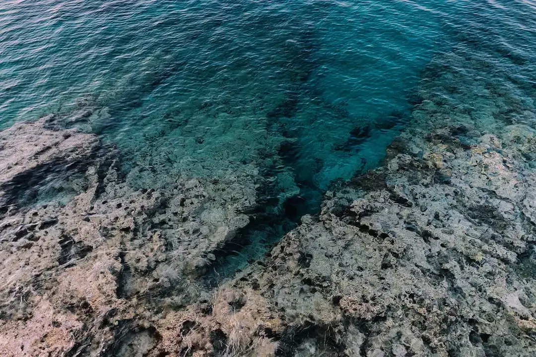 A serene view of the deep blue Mediterranean Sea underwater with sunlight filtering through the ripples.