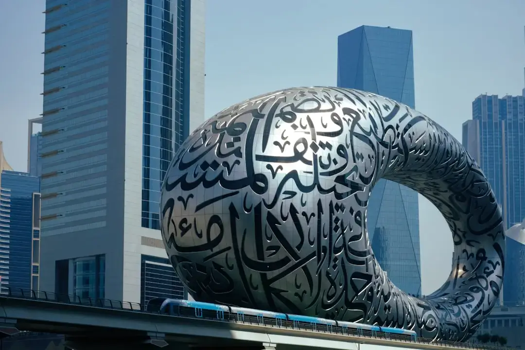 Panoramic view of the futuristic Dubai skyline with modern skyscrapers and iconic architecture under a clear blue sky.