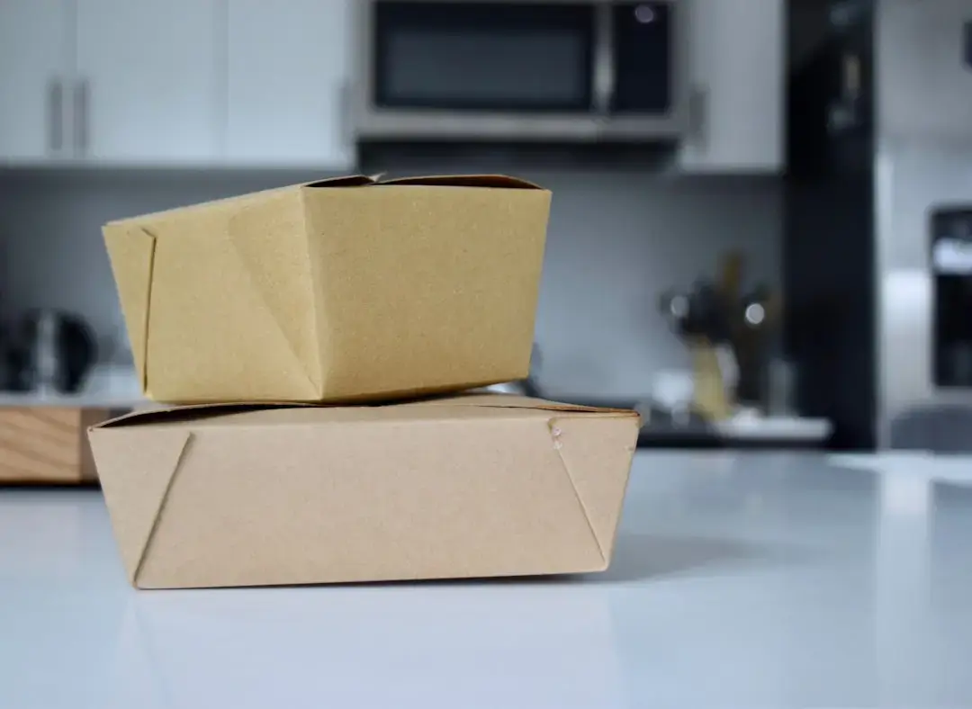 Biodegradable and sustainable packaging products made from corn-based materials on a clean background