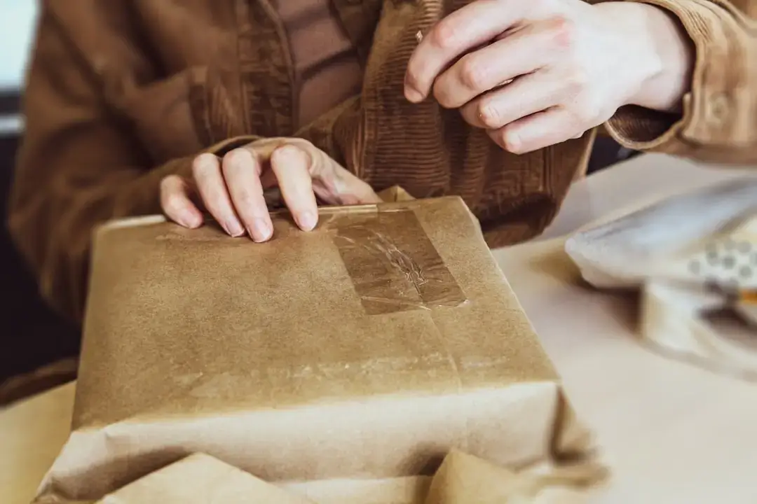 Close-up of an eco-friendly label on sustainable brown paper packaging emphasizing environmental protection.