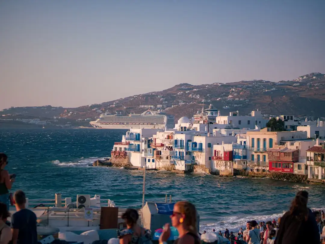 A happy family enjoying a sunny vacation overlooking the blue waters and white architecture of a Greek island.