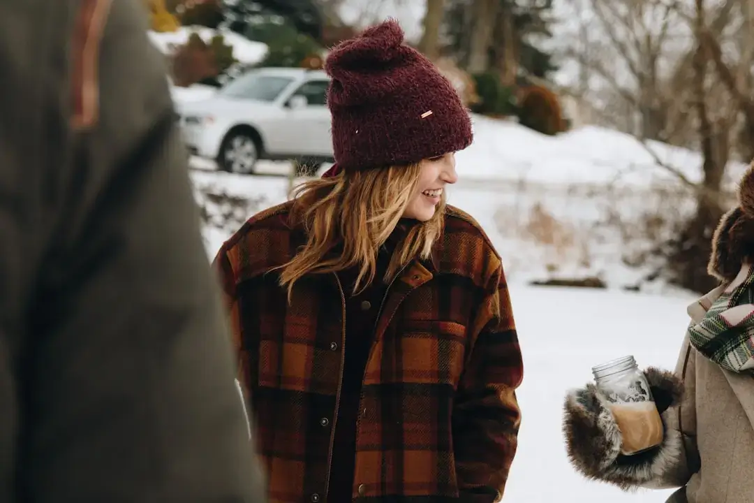 A happy family with children dressed in warm winter gear planning a holiday trip together in a cozy setting.