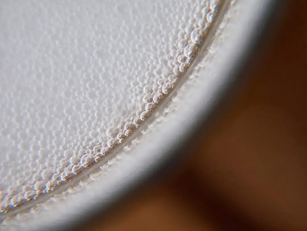A clear glass filled with cold, fresh white milk on a clean table