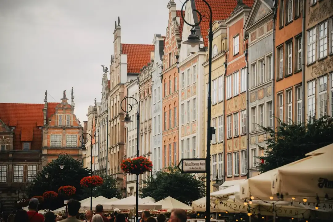 A stunning sunset view over the historic colorful buildings and cobblestone streets of Gdansk Old Town in Poland.