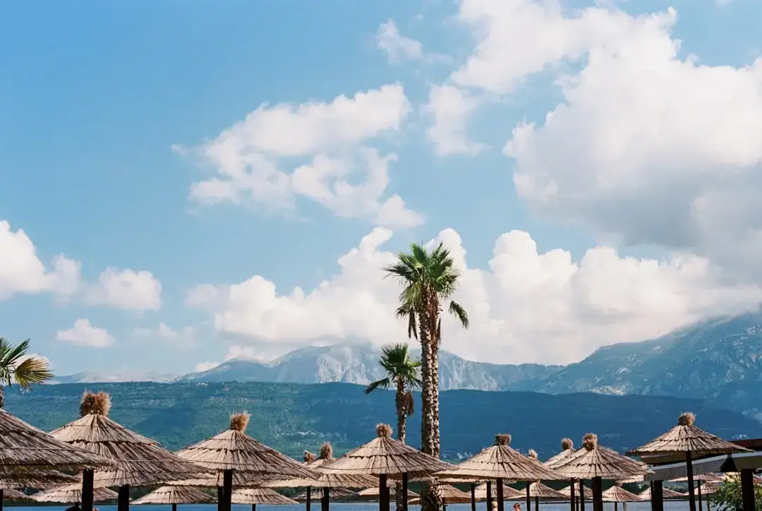 Aerial view of a luxury summer resort with turquoise water and swimming pools on the Turkish Mediterranean coast.