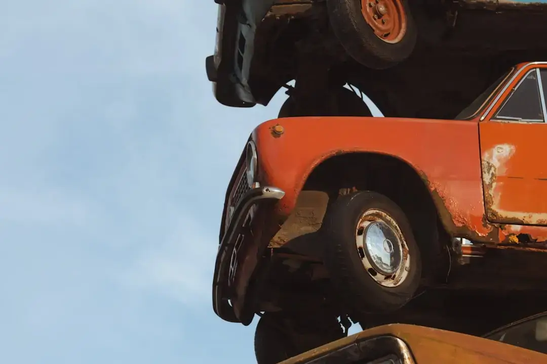 A professional car dismantling station with organized vehicle parts and industrial equipment for recycling.