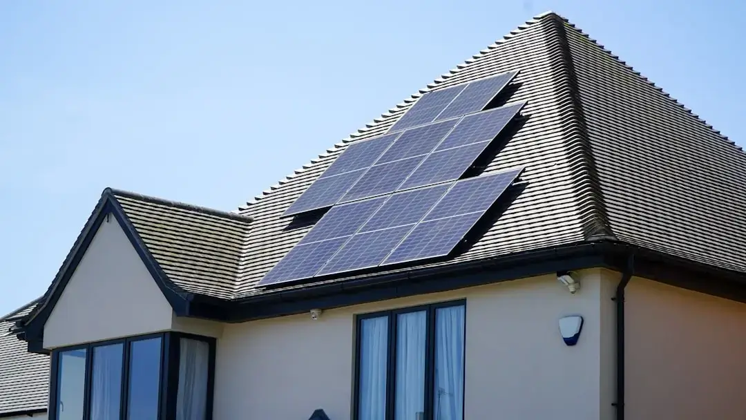 Close-up of sleek black solar panels installed on a modern residential house roof for sustainable energy