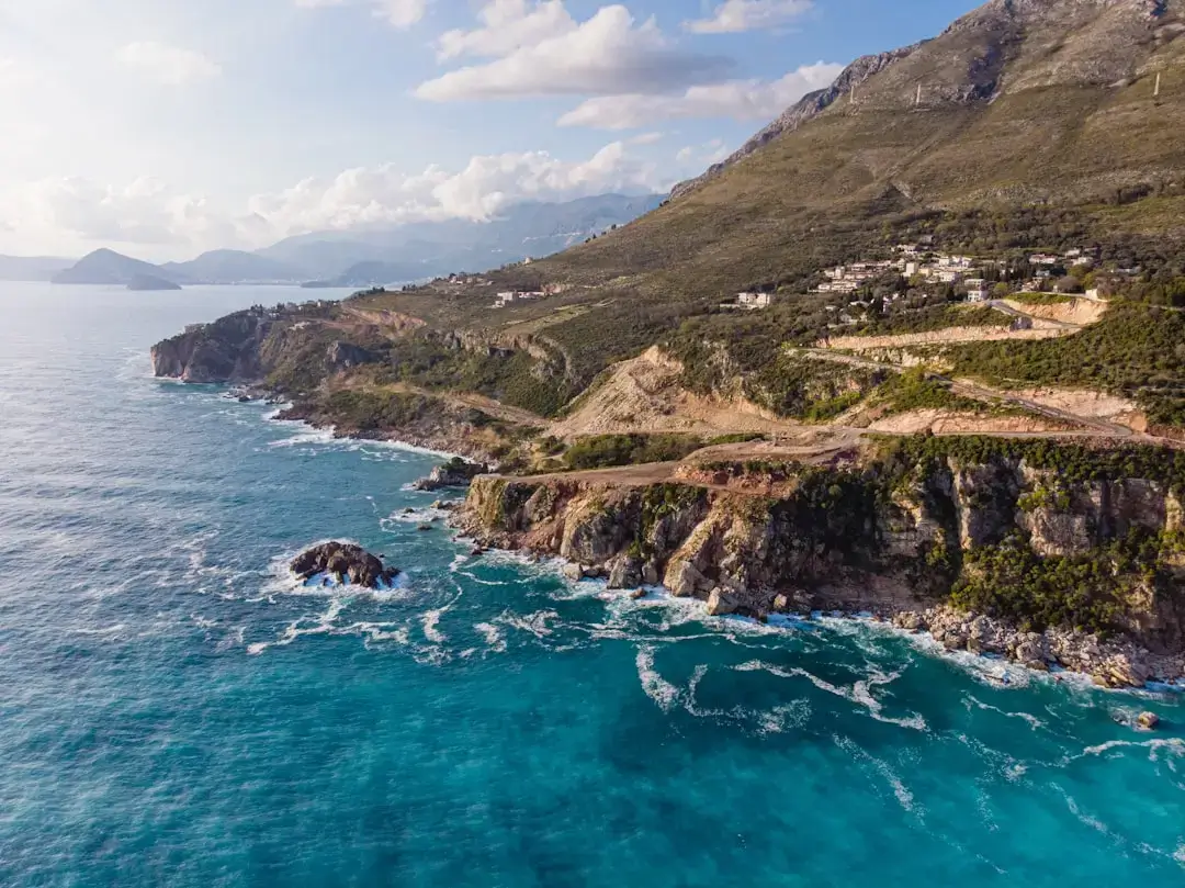 Panoramic view of the crystal clear turquoise water along the rugged Adriatic coastline in Montenegro.