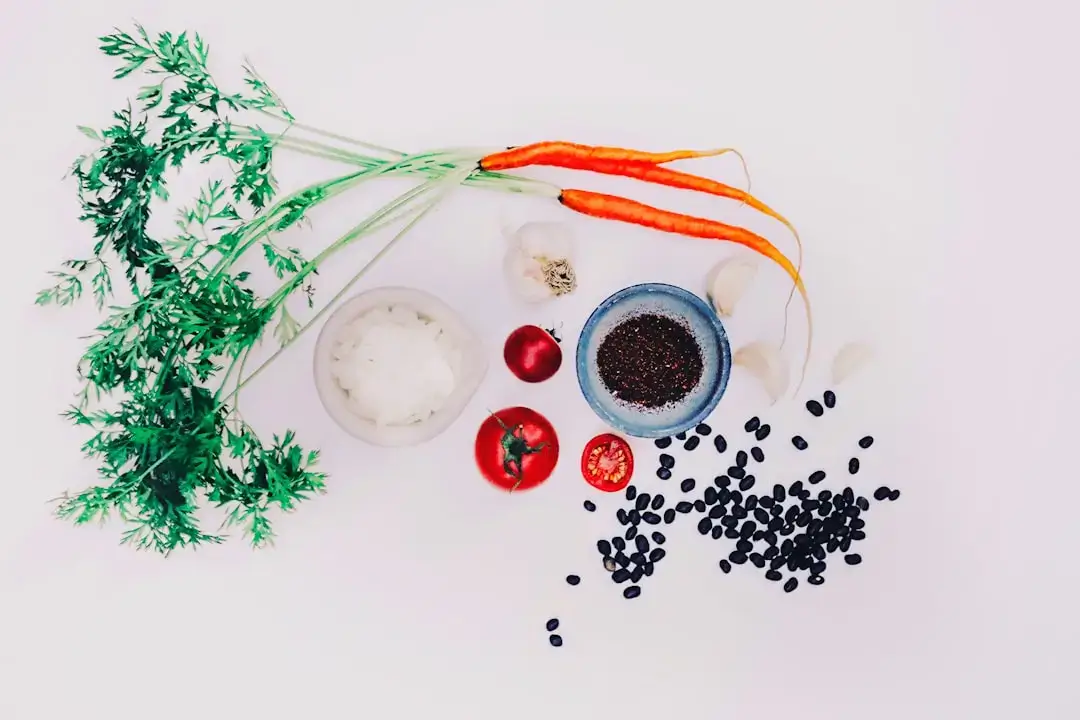 An assortment of fresh organic vegetables and fruits on a wooden table representing a healthy balanced diet.