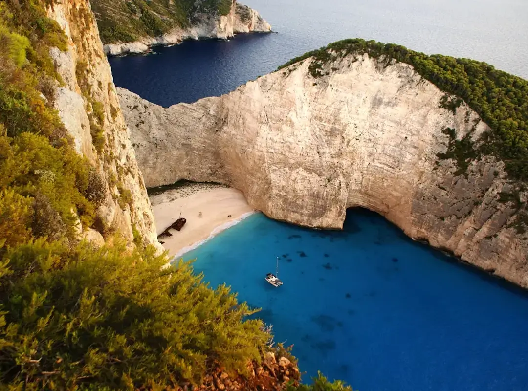 Aerial view of the iconic shipwreck on Navagio Beach with turquoise waters and limestone cliffs in Zakynthos, Greece