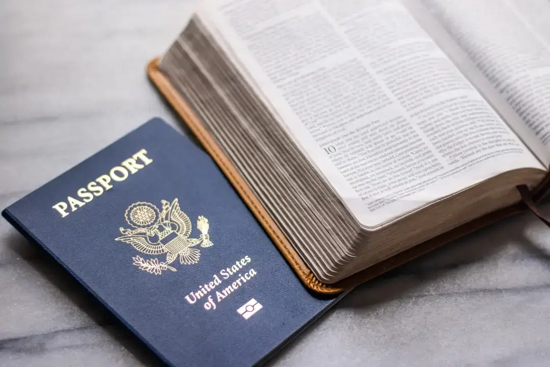 A close-up shot of a passport and essential travel documents prepared for an international journey.