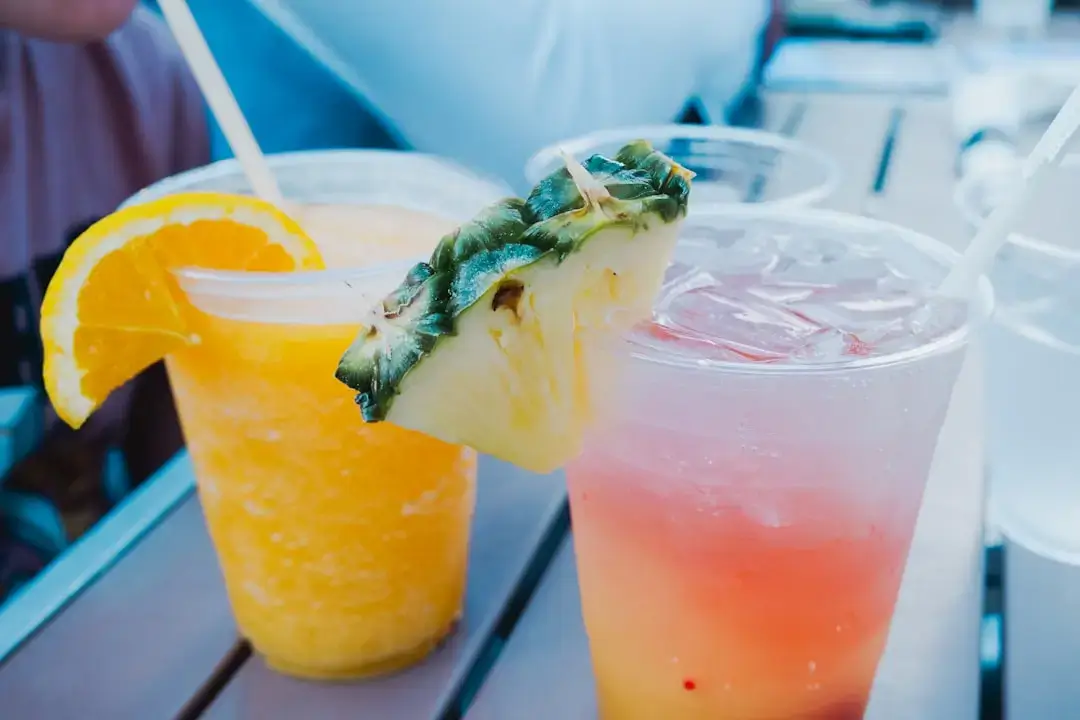 A selection of colorful refreshing exotic fruit drinks served with ice and tropical garnishes