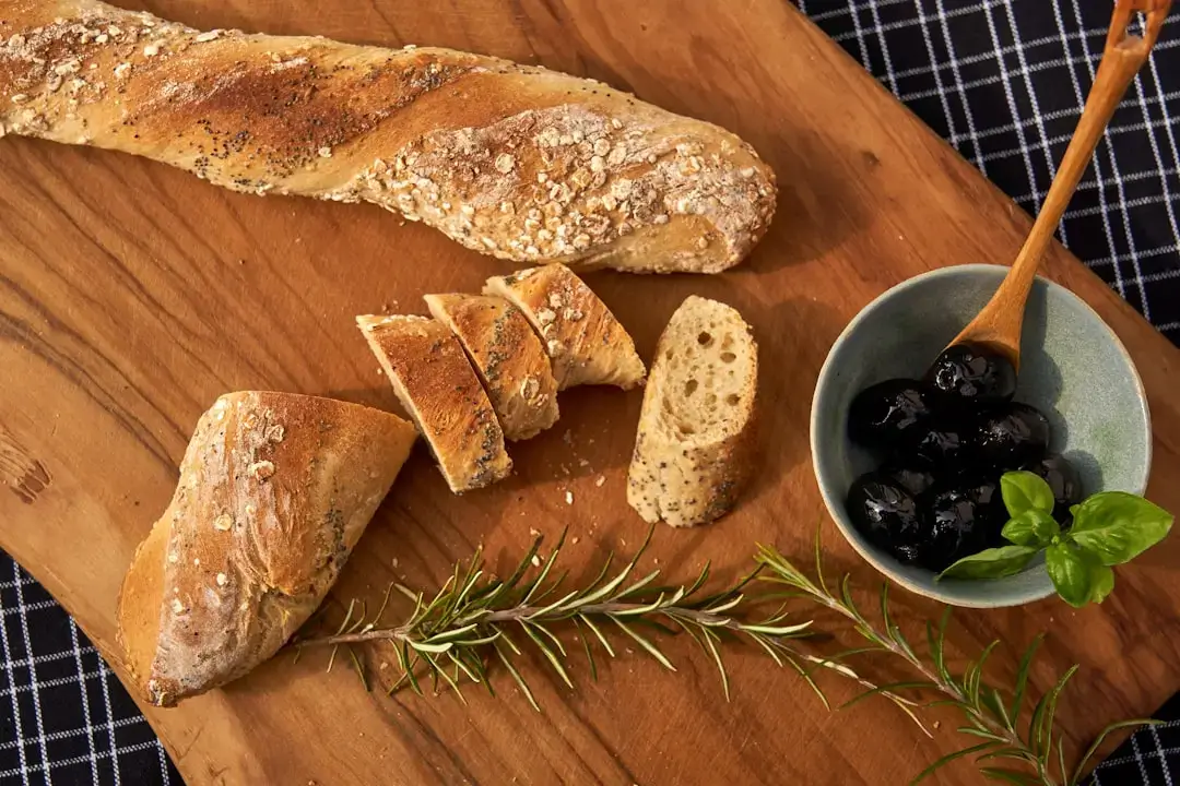 Close-up of crusty stale bread being repurposed into a sustainable meal in a rustic kitchen setting.