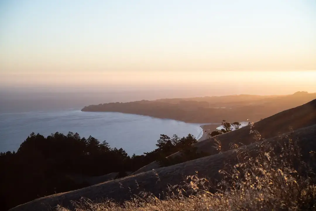 Panoramic view of a golden sunset over the coastal landscape and crystal clear waters of Rhodes, Greece.