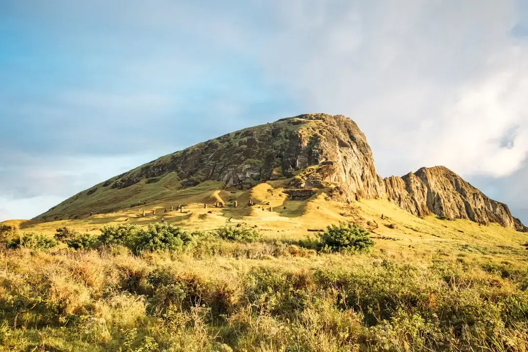 A breathtaking panoramic view of the volcanic mountains and dramatic coastline of the Canary Islands under a clear blue sky.
