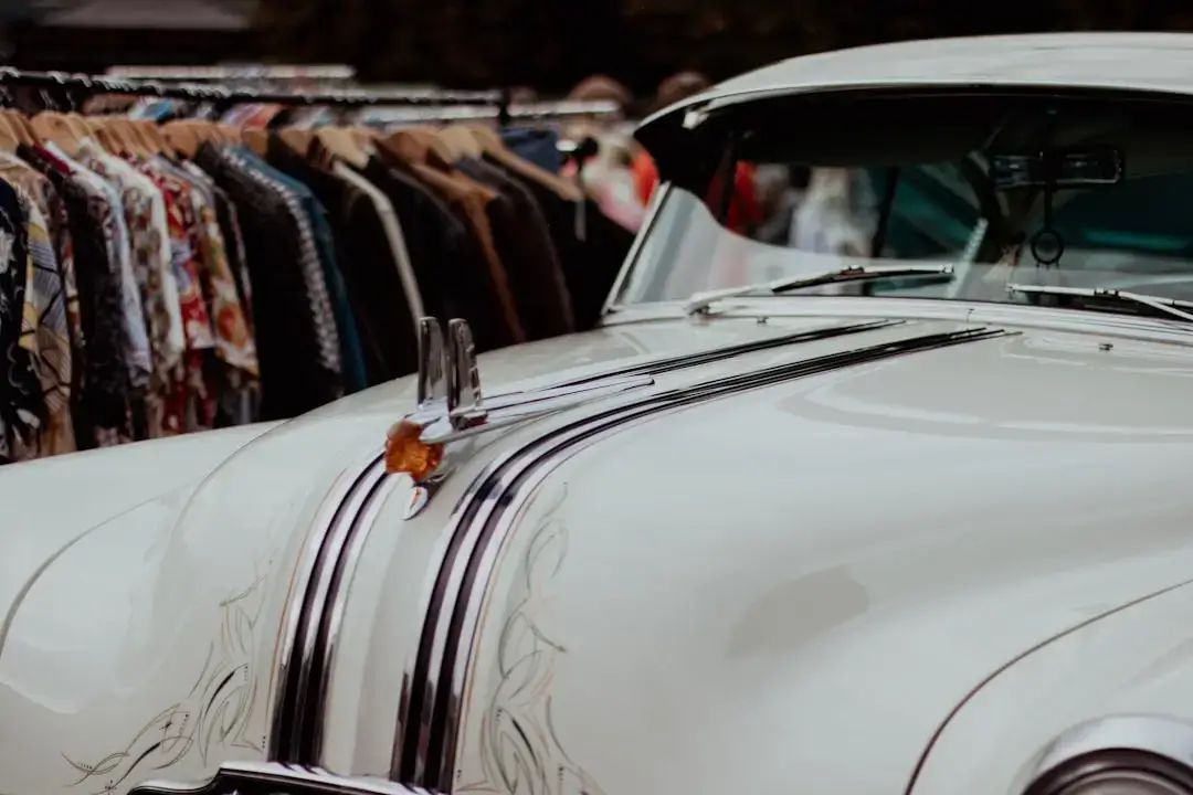 A colorful selection of vintage and secondhand garments hanging neatly on a clothing rack in a thrift department.