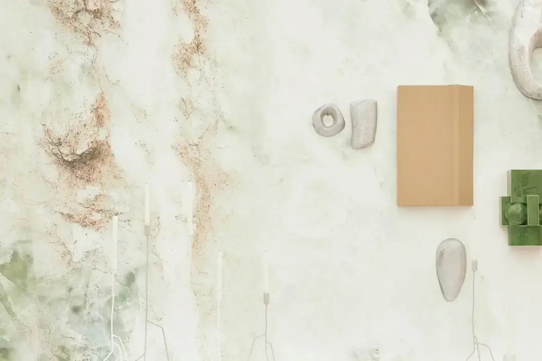 High-angle flatlay of various sustainable lifestyle items including reusable bags, bamboo products, and organic textiles on a light surface.