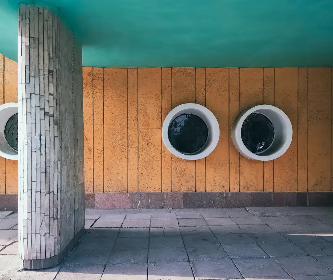 three round windows on the side of a building