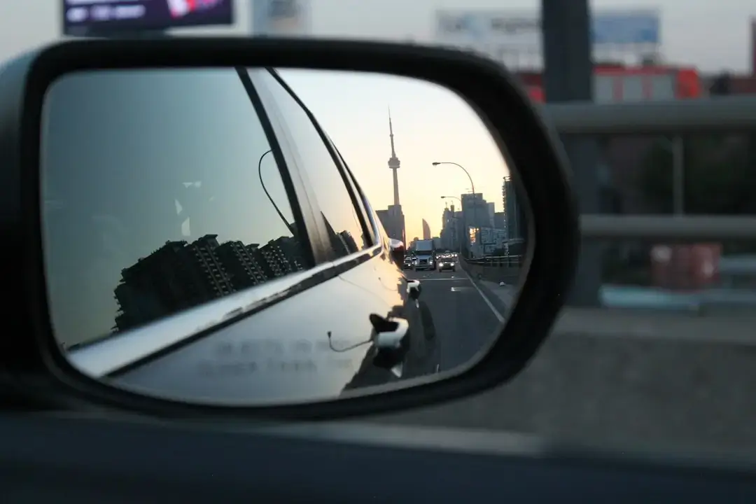 A breathtaking view of the CN Tower rising above the Toronto city skyline during sunset.