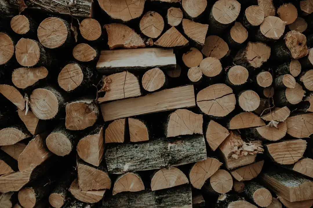 A powerful wood chipper machine processing branches and organic garden waste in a backyard setting.