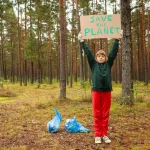 a person holding a sign in the woods