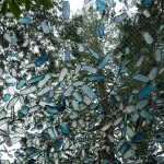 Blue and white objects hanging from tree branches