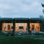 Modern building with large glass windows at dusk