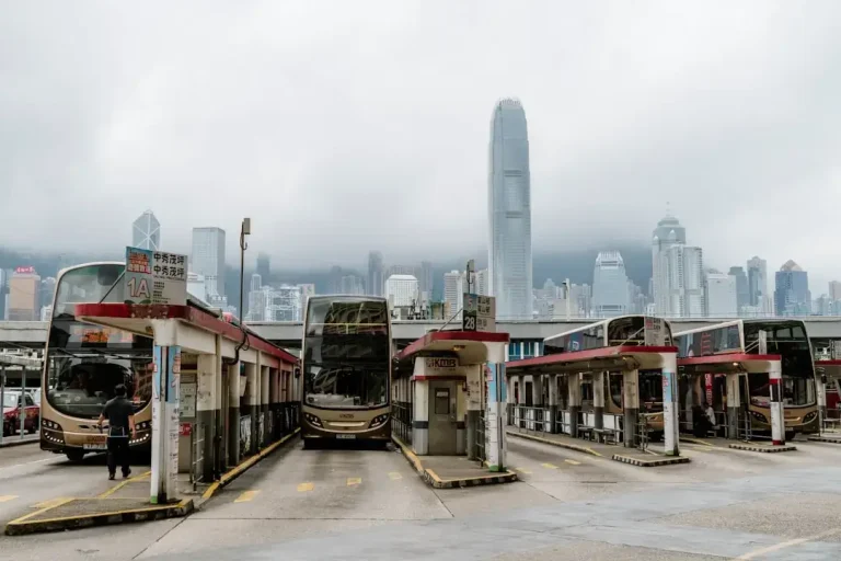 Buses are parked at a bus terminal in hong kong.