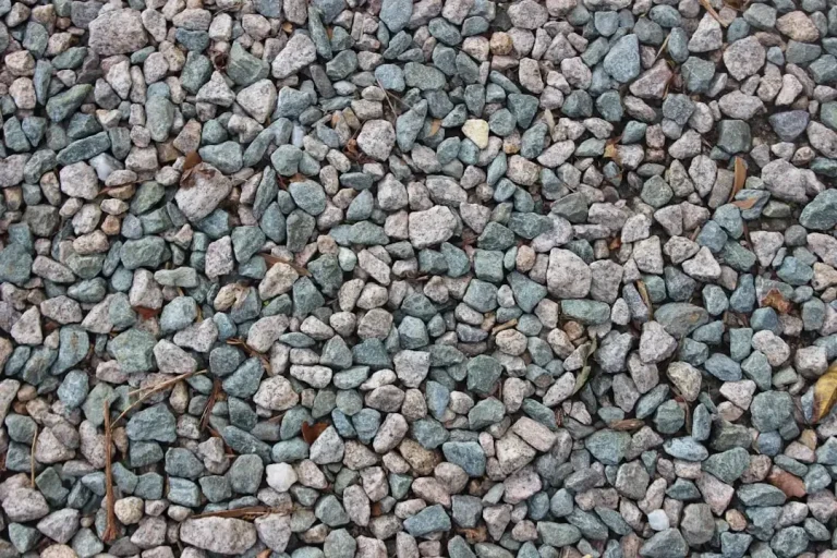 A pile of dark grey granulated basalt stone grit used for soil enhancement and construction.