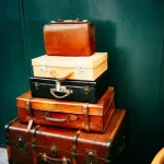 An old vintage suitcase placed outdoors, representing luggage disposal and waste recycling.