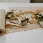 Colorful cotton fabric patterns being coated with melted beeswax to create reusable eco-friendly food wraps