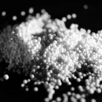 Colorful raw polymer pellets used as the primary material for manufacturing plastic products