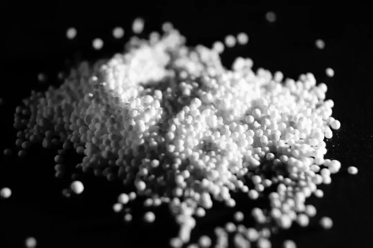 Colorful raw polymer pellets used as the primary material for manufacturing plastic products
