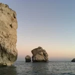 A beautiful view of the crystal clear turquoise sea and rocky coastline in Cyprus during the sunny month of May.