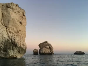 A beautiful view of the crystal clear turquoise sea and rocky coastline in Cyprus during the sunny month of May.